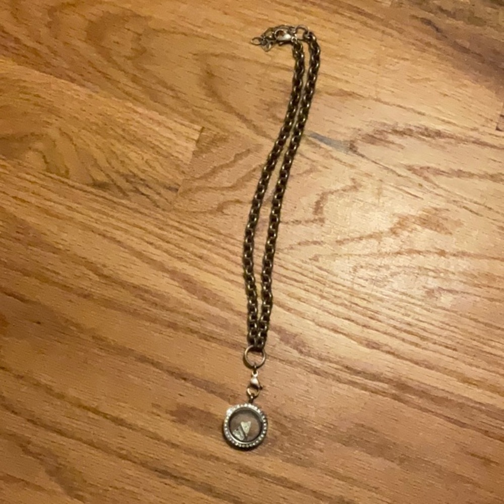 A locket that is in mid condition and has to letter a’s in it